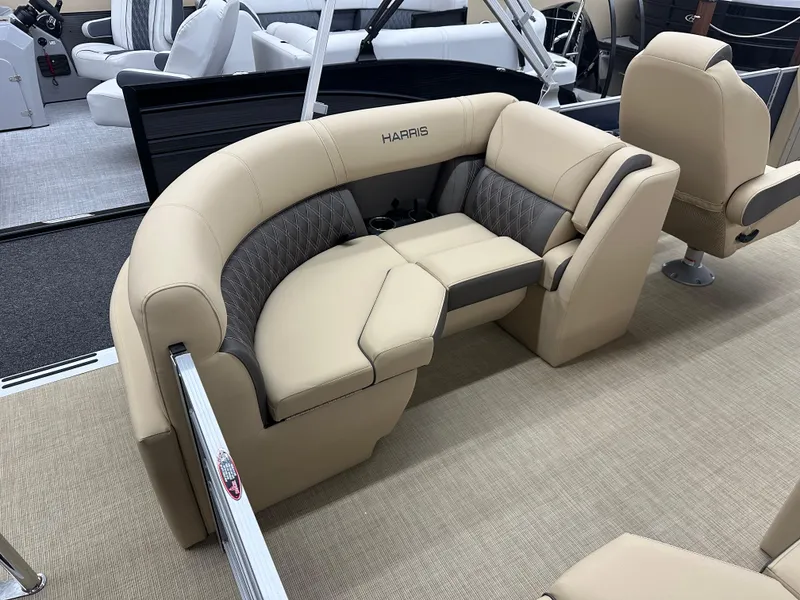 Slide: The Image of 2024 Harris Sunliner 230 boat interior with beige and gray seating. - 10