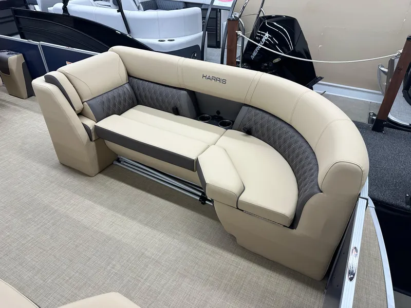 Slide: The Image of 2024 Harris Sunliner 230 boat seating with beige upholstery and cup holders. - 3