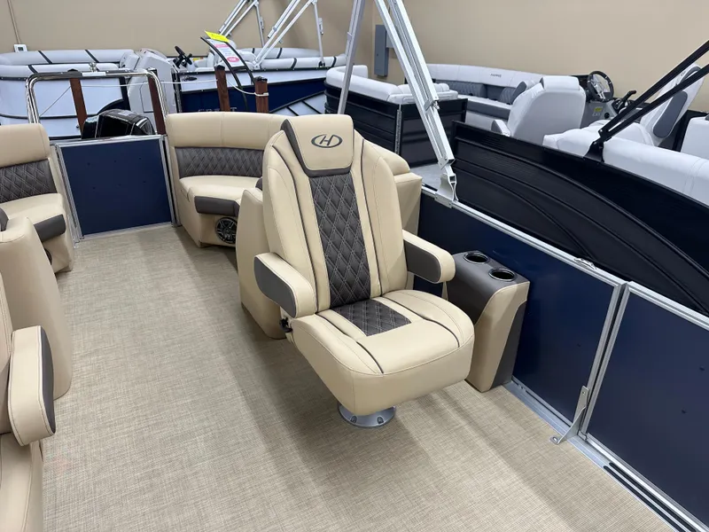 Slide: The Image of 2024 Harris Sunliner 230 boat interior with beige seating and modern design. - 6