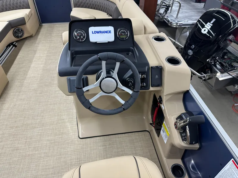 Slide: The Image of 2024 Harris Sunliner 230 boat dashboard with Lowrance display and steering wheel. - 8