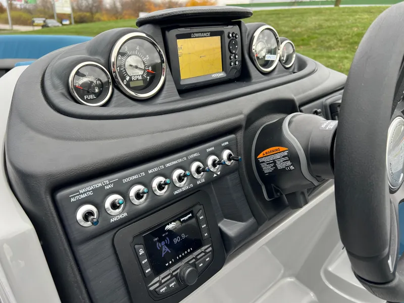 Slide: The Image of 2025 South Bay S224UL boat dashboard with gauges, navigation system, and control switches. - 20