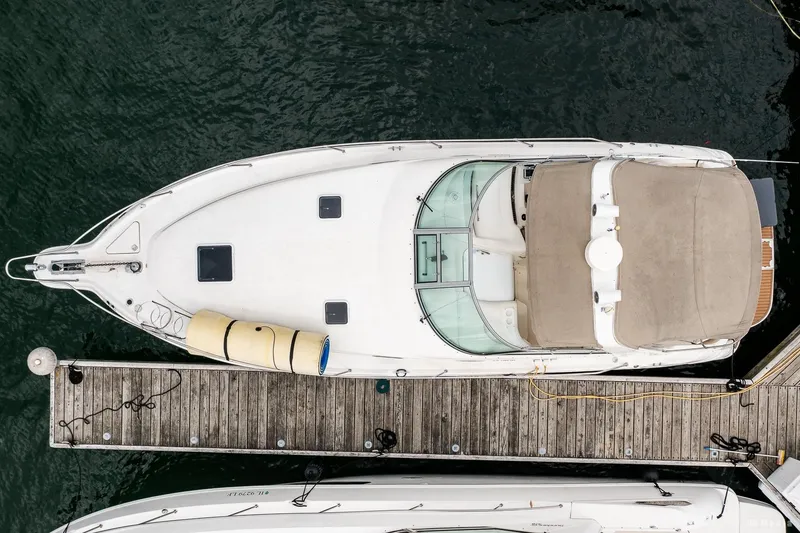 Slide: The Image of Overhead view of a 1998 Sea Ray 330 Sundancer docked at a marina. - 14