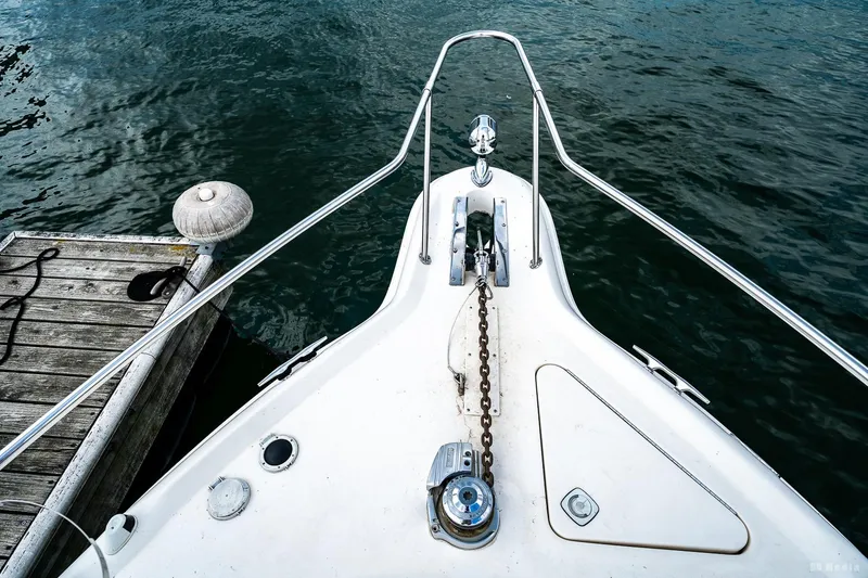 Slide: The Image of Bow of 1998 Sea Ray 330 Sundancer at dock, featuring anchor and chain. - 16