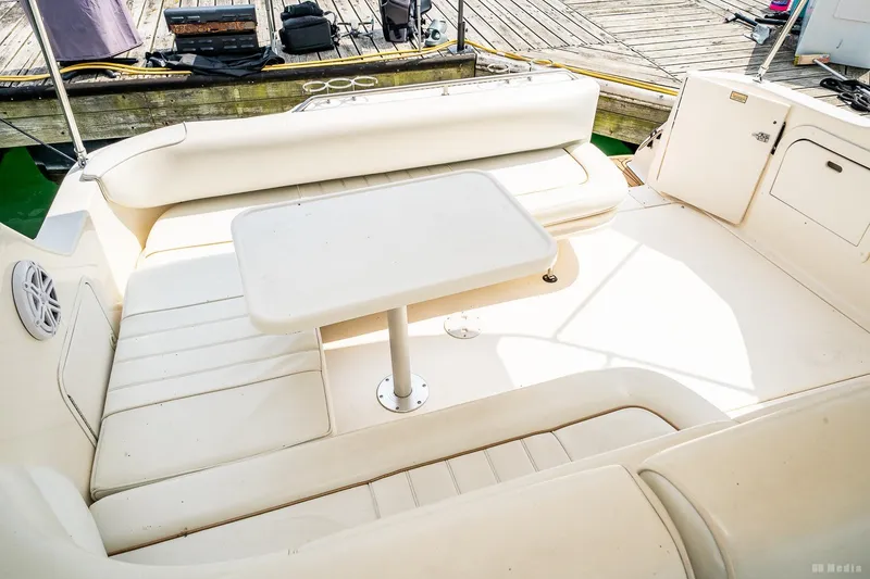 Slide: The Image of 1998 Sea Ray 330 Sundancer boat interior with white seating and table. - 21