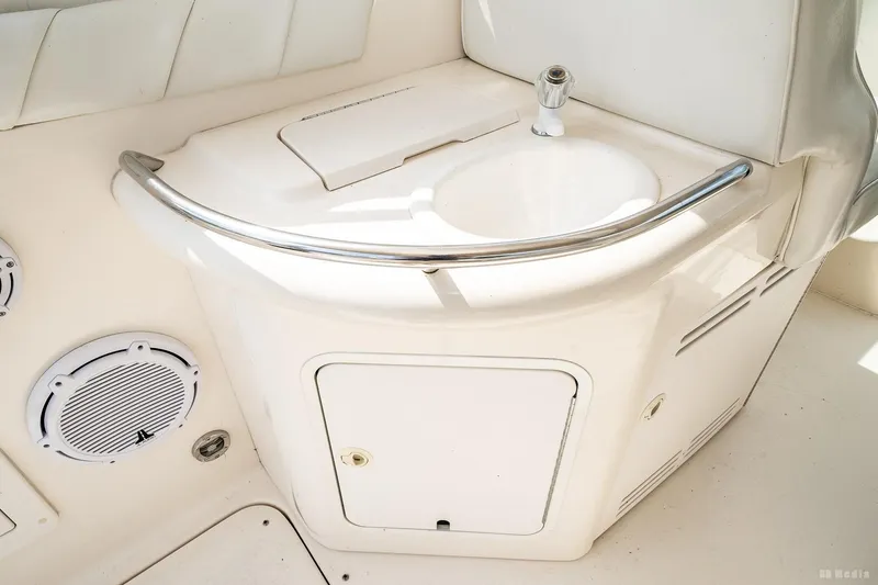 Slide: The Image of 1998 Sea Ray 330 Sundancer boat interior with sink and speaker. - 23