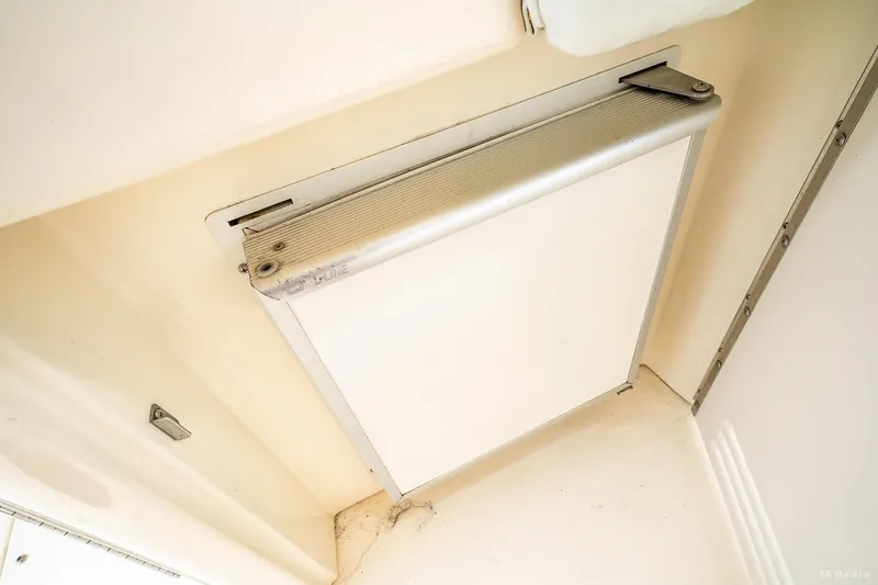 Slide: The Image of 1998 Sea Ray 330 Sundancer interior detail, featuring a compact storage compartment. - 24