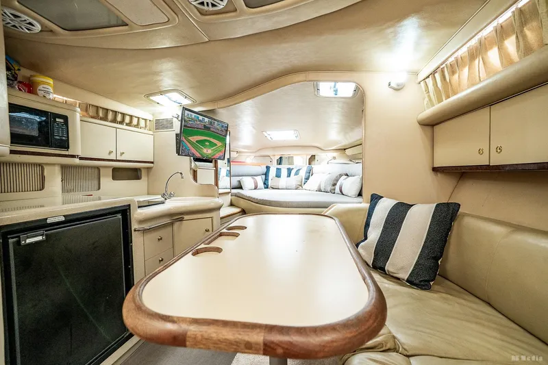 Slide: The Image of Interior of 1998 Sea Ray 330 Sundancer yacht with cozy seating and modern amenities. - 33