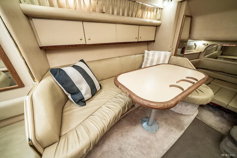 Slide: The Image of Interior of 1998 Sea Ray 330 Sundancer yacht with cozy seating and table. - 34