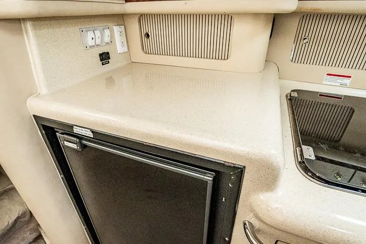 Slide: The Image of 1998 Sea Ray 330 Sundancer interior with countertop, fridge, and electrical outlets. - 42