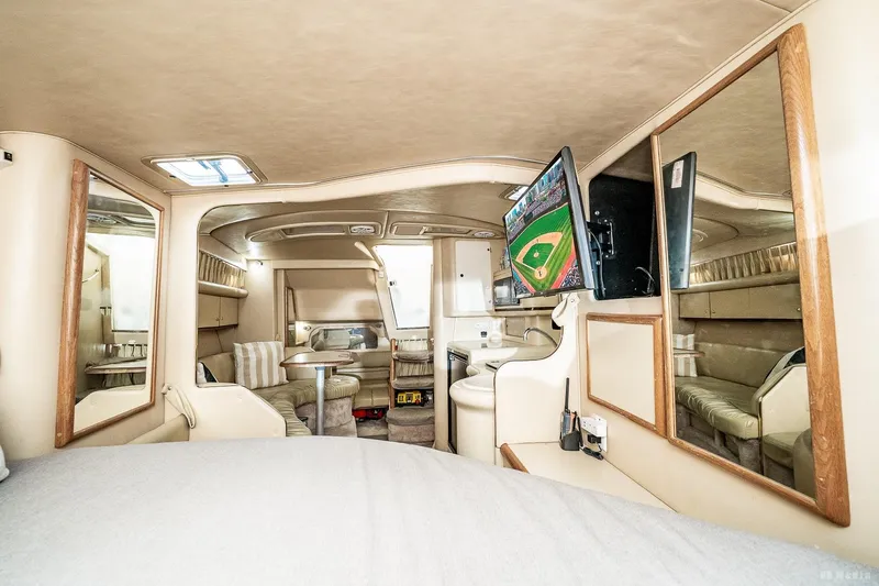 Slide: The Image of Interior of 1998 Sea Ray 330 Sundancer yacht with cozy seating and mounted TV. - 46