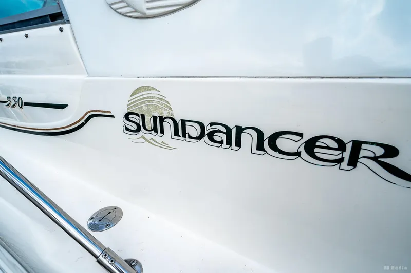 Slide: The Image of Close-up of 1998 Sea Ray 330 Sundancer boat logo and branding. - 53