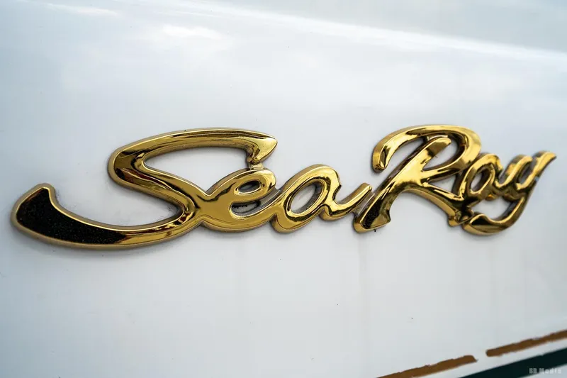 Slide: The Image of Gold "Sea Ray" logo on a 1998 Sea Ray 330 Sundancer boat. - 54