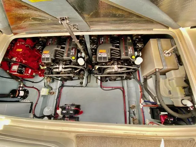 Slide: The Image of Engine compartment of 1998 Sea Ray 330 Sundancer with twin engines and mechanical components. - 55