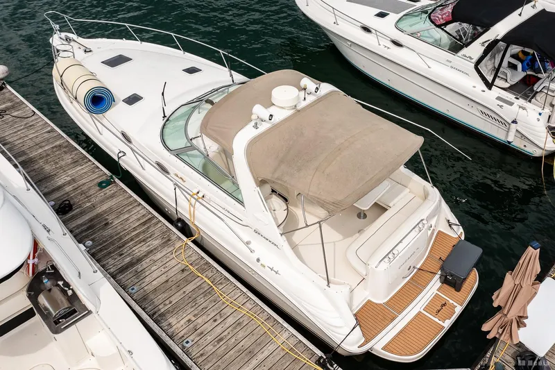 Slide: The Image of 1998 Sea Ray 330 Sundancer docked, aerial view, showcasing deck and canopy. - 9