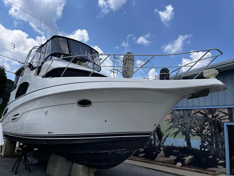 Slide: The Image of 2004 Silverton 39 Motor Yacht on display against a blue sky backdrop. - 1
