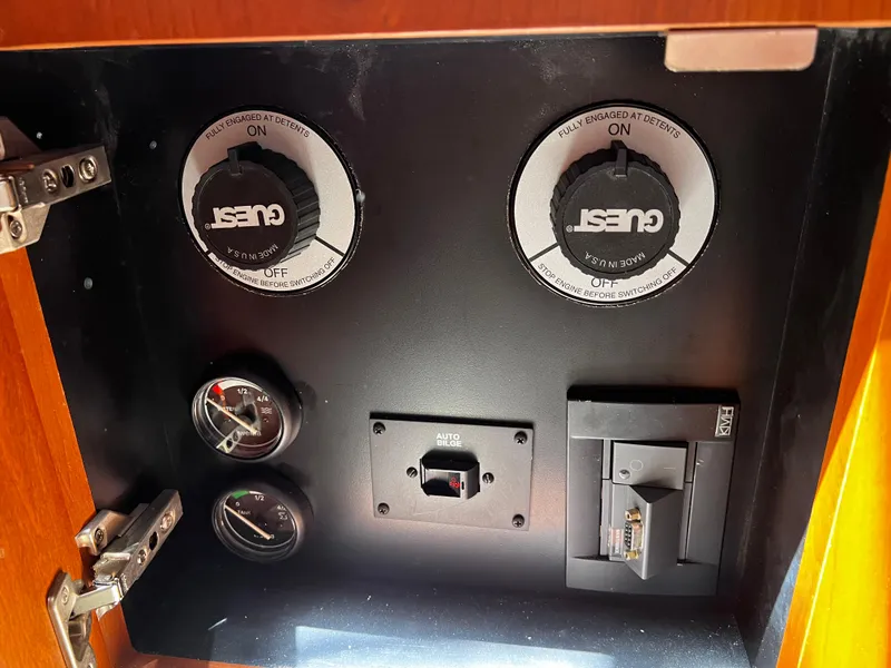 Slide: The Image of Control panel of a 2004 Silverton 39 Motor Yacht with gauges and switches. - 12