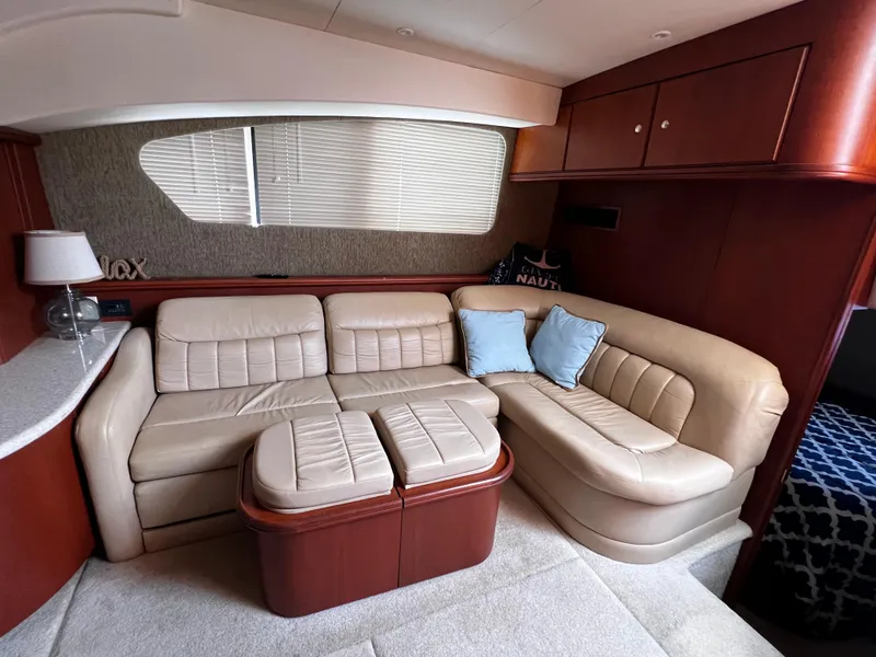 Slide: The Image of Luxurious interior of 2004 Silverton 39 Motor Yacht with beige leather seating and wooden accents. - 14