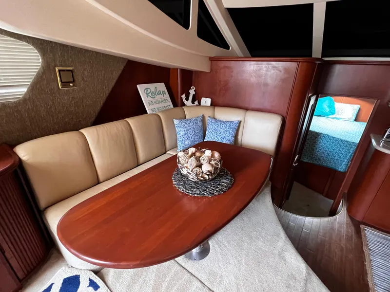 Slide: The Image of Luxurious interior of 2004 Silverton 39 Motor Yacht with elegant dining area and cozy seating. - 15