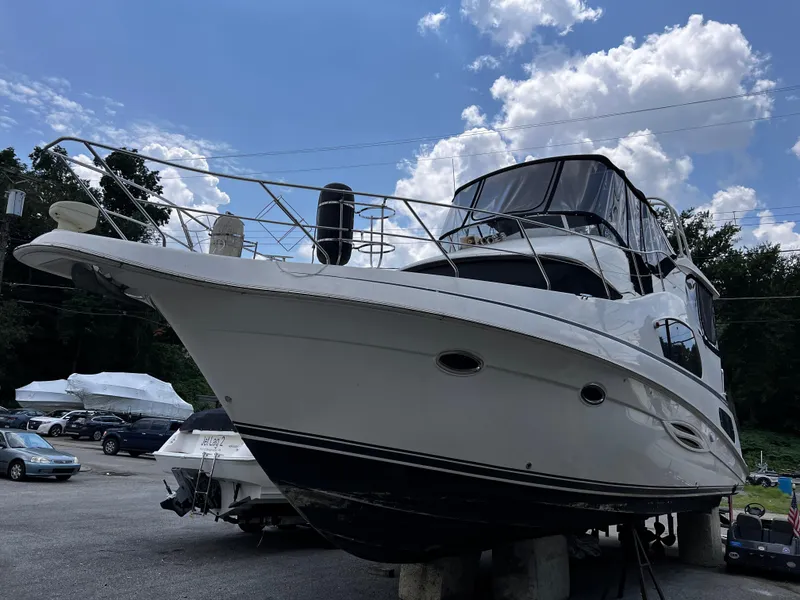Slide: The Image of 2004 Silverton 39 Motor Yacht on dry dock under a clear blue sky. - 2
