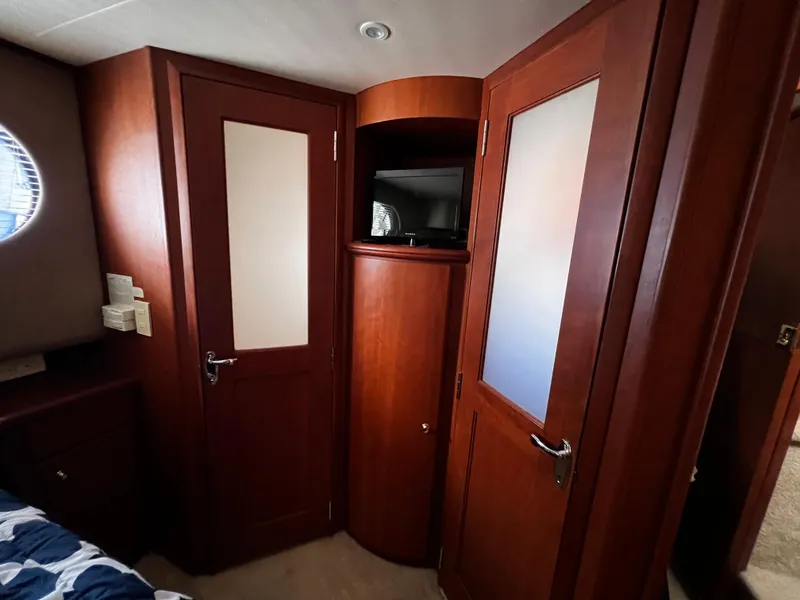 Slide: The Image of Interior of 2004 Silverton 39 Motor Yacht with wooden doors and built-in TV. - 21