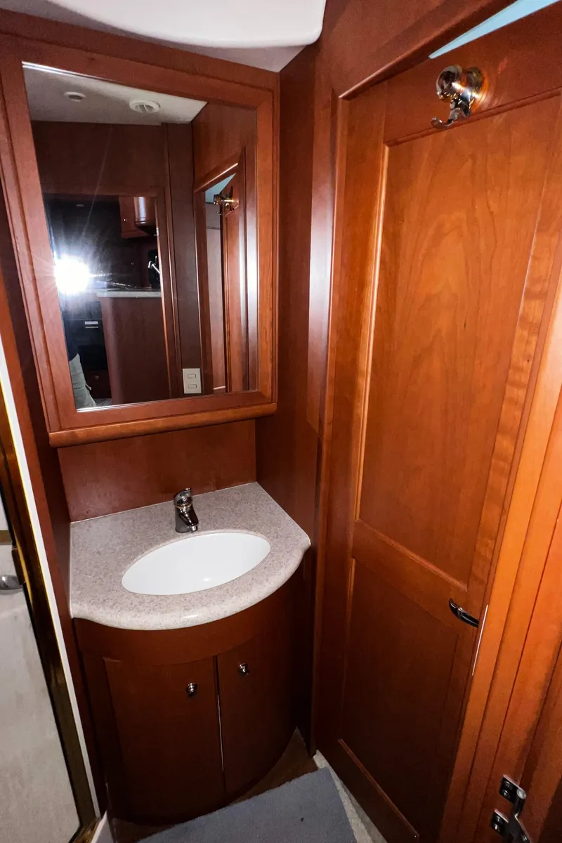 Slide: The Image of 2004 Silverton 39 Motor Yacht bathroom with wood cabinetry and sink. - 23