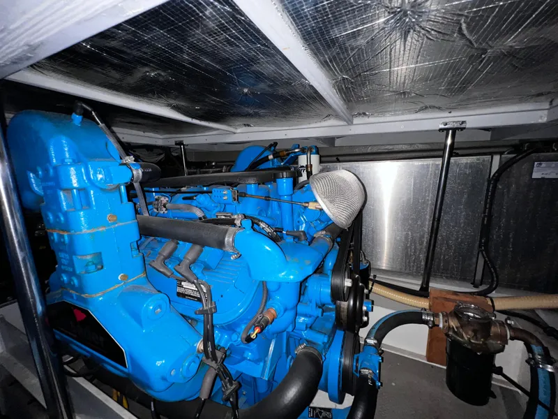 Slide: The Image of Engine room of 2004 Silverton 39 Motor Yacht with blue machinery and insulated ceiling. - 25