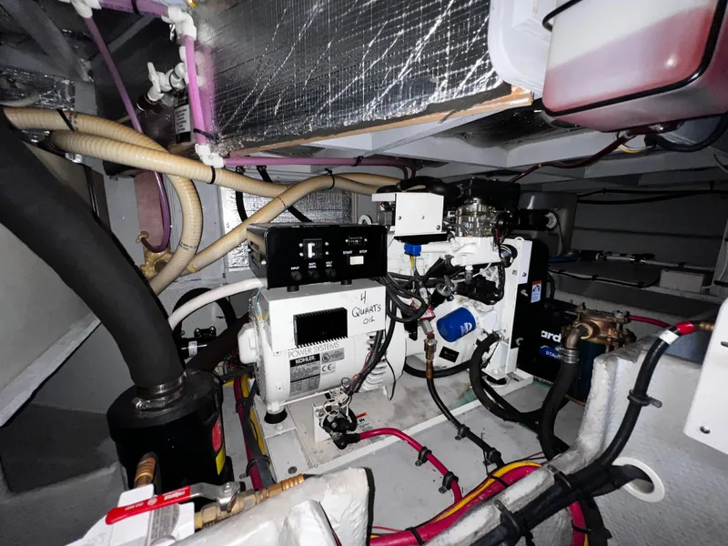 Slide: The Image of Engine room of 2004 Silverton 39 Motor Yacht with visible wiring and machinery. - 26