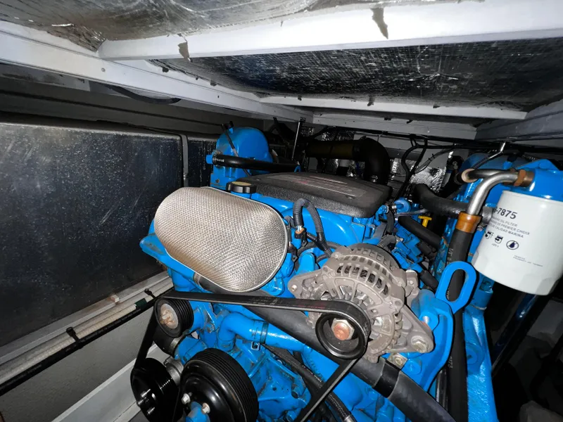 Slide: The Image of Engine room of a 2004 Silverton 39 Motor Yacht, showcasing a blue marine engine. - 29