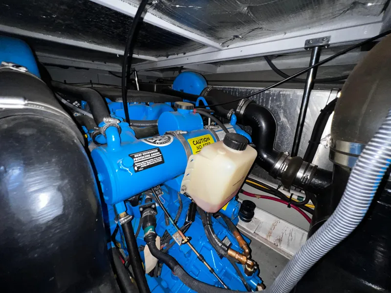 Slide: The Image of Engine room of 2004 Silverton 39 Motor Yacht, featuring blue engine components. - 32