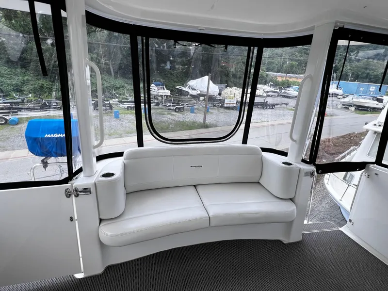 Slide: The Image of 2004 Silverton 39 Motor Yacht interior with white seating and large windows. - 5