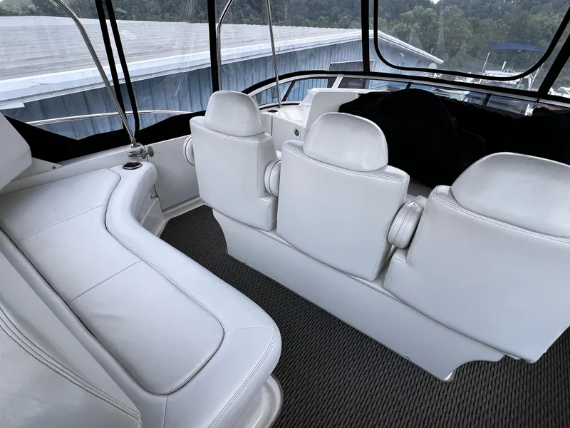 Slide: The Image of 2004 Silverton 39 Motor Yacht interior with white seating and panoramic windows. - 7
