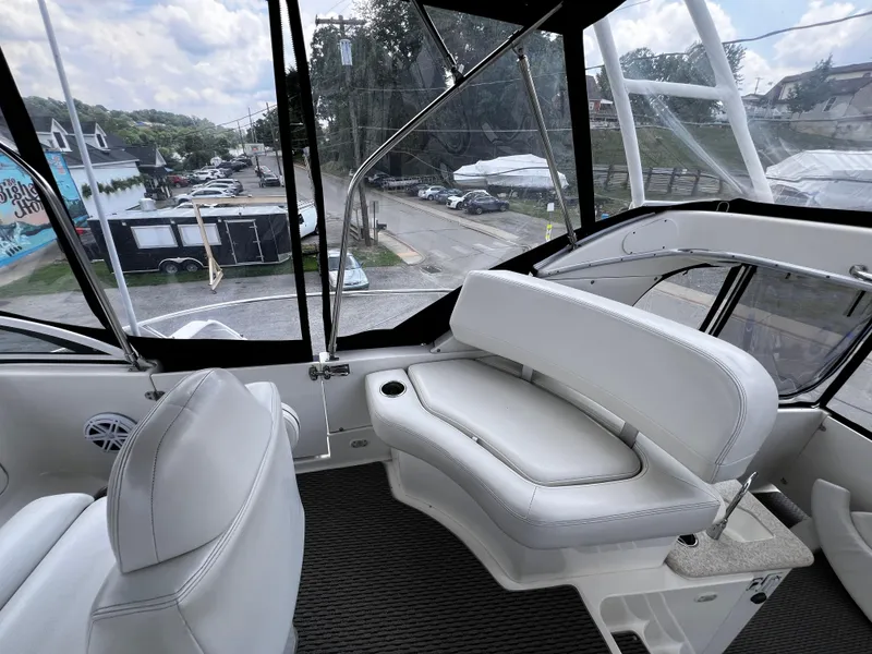 Slide: The Image of 2004 Silverton 39 Motor Yacht interior with white seating and panoramic windows. - 8