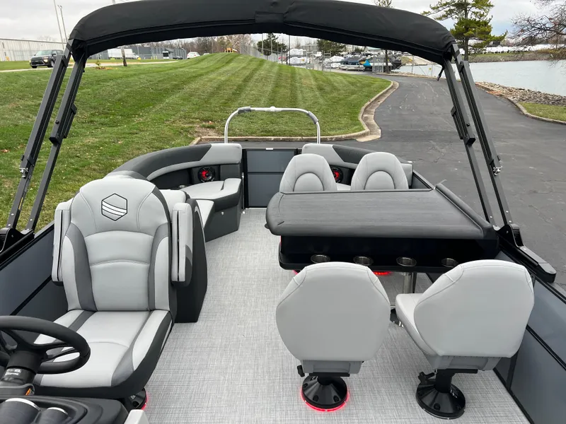 Slide: The Image of 2025 South Bay S224 Entertainer 3.0 pontoon boat interior with seating and table. - 10