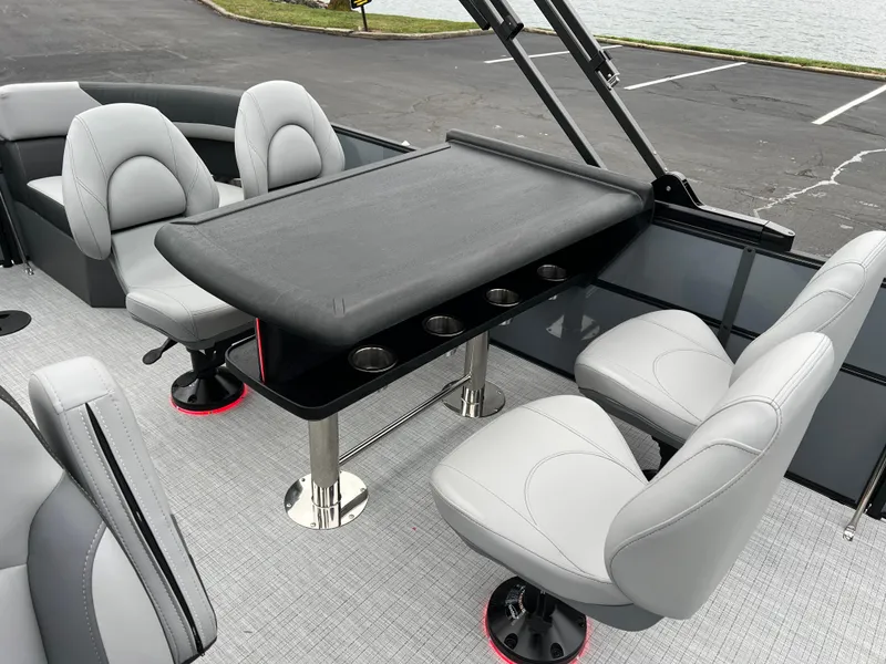 Slide: The Image of 2025 South Bay S224 Entertainer 3.0 boat interior with sleek seating and table. - 11