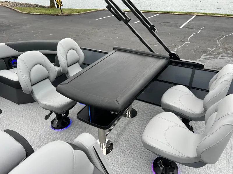 Slide: The Image of 2025 South Bay S224 Entertainer 3.0 boat interior with sleek seating and table. - 12