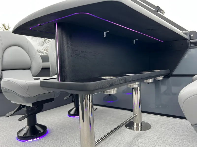Slide: The Image of 2025 South Bay S224 Entertainer 3.0 boat interior with modern seating and LED lighting. - 13