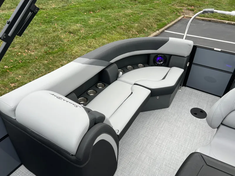Slide: The Image of 2025 South Bay S224 Entertainer 3.0 boat interior with sleek seating and cup holders. - 14