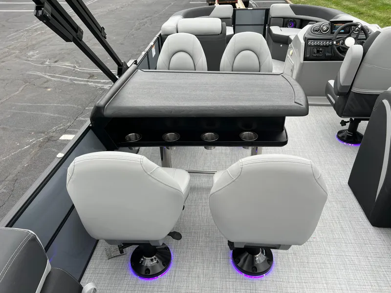 Slide: The Image of 2025 South Bay S224 Entertainer 3.0 boat interior with modern seating and table setup. - 16
