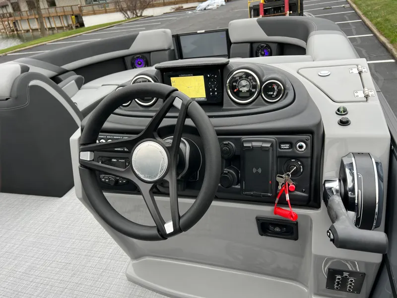 Slide: The Image of 2025 South Bay S224 Entertainer 3.0 boat dashboard with steering wheel and controls. - 20