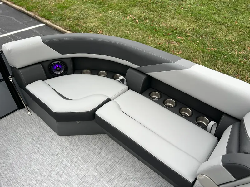 Slide: The Image of 2025 South Bay S224 Entertainer 3.0 boat interior with sleek gray seating and cup holders. - 22