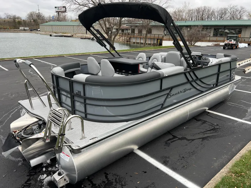 Slide: The Image of 2025 South Bay S224 Entertainer 3.0 pontoon boat parked near a lake. - 4