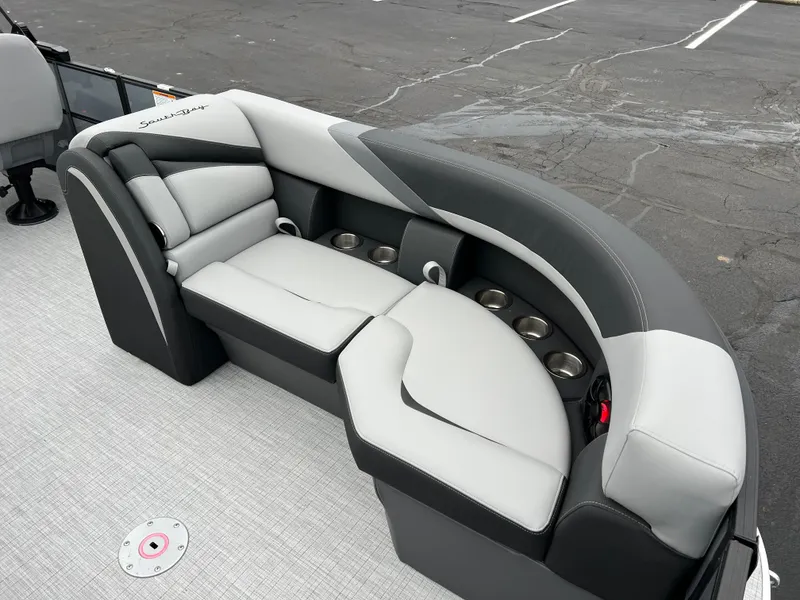 Slide: The Image of 2025 South Bay S224 Entertainer 3.0 boat seating with cup holders, gray upholstery. - 7