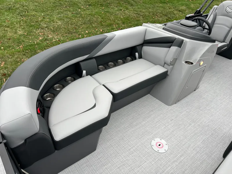 Slide: The Image of 2025 South Bay S224 Entertainer 3.0 boat interior with sleek seating and cup holders. - 8