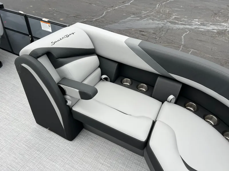 Slide: The Image of 2025 South Bay S224 Entertainer 3.0 boat seating with sleek gray and white upholstery. - 9
