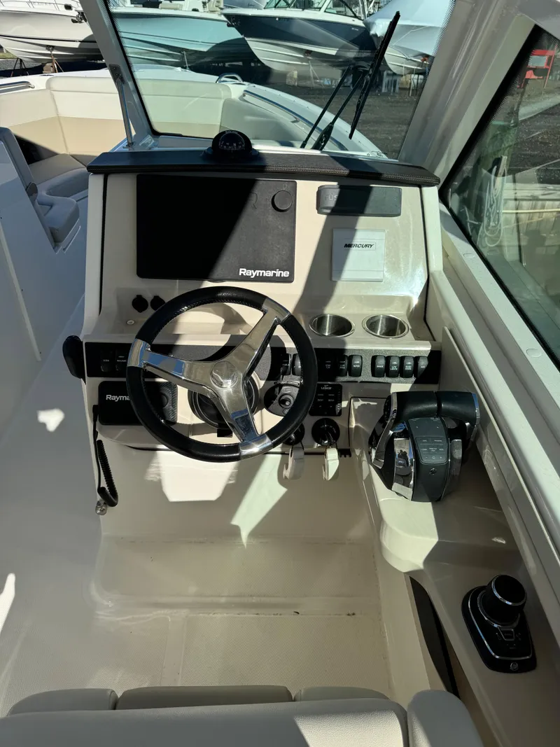 Slide: The Image of 2021 Boston Whaler 280 Vantage helm with modern controls and navigation system. - 2