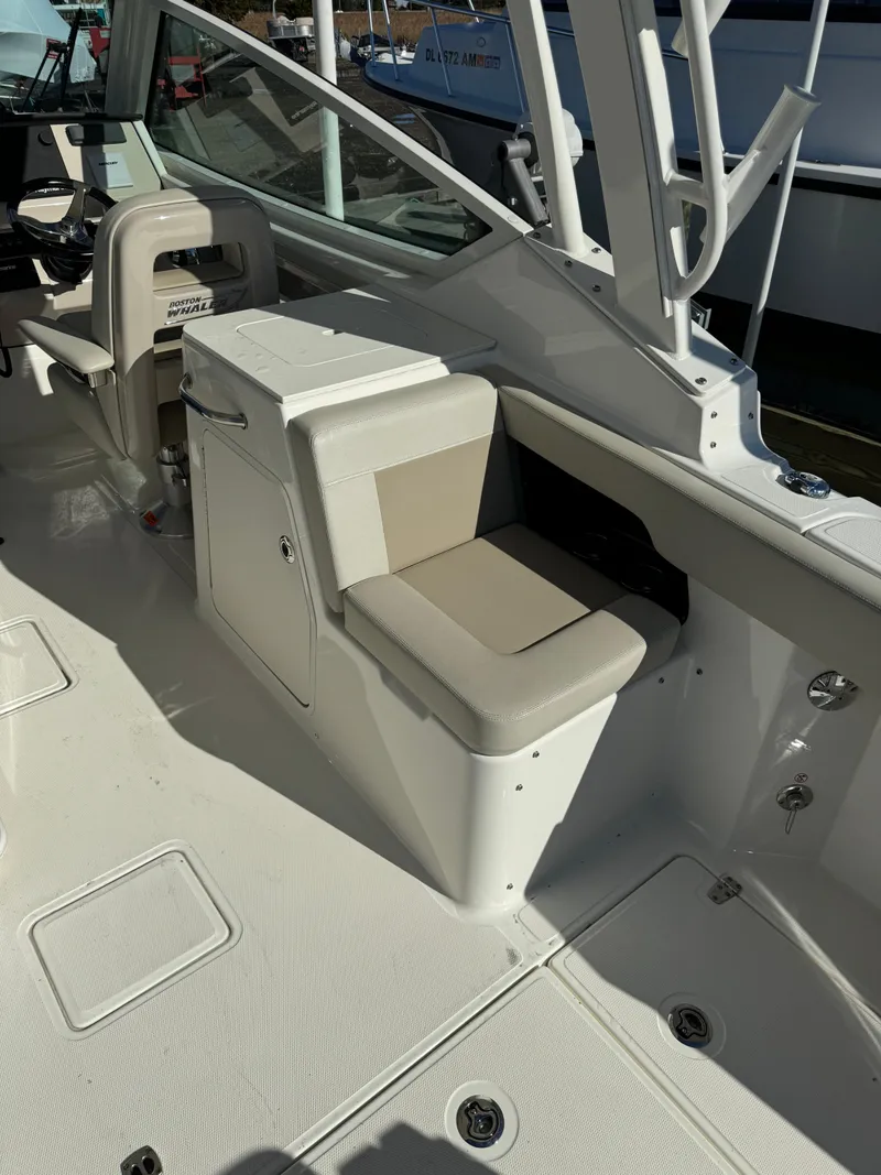 Slide: The Image of 2021 Boston Whaler 280 Vantage boat interior with seating and storage. - 5