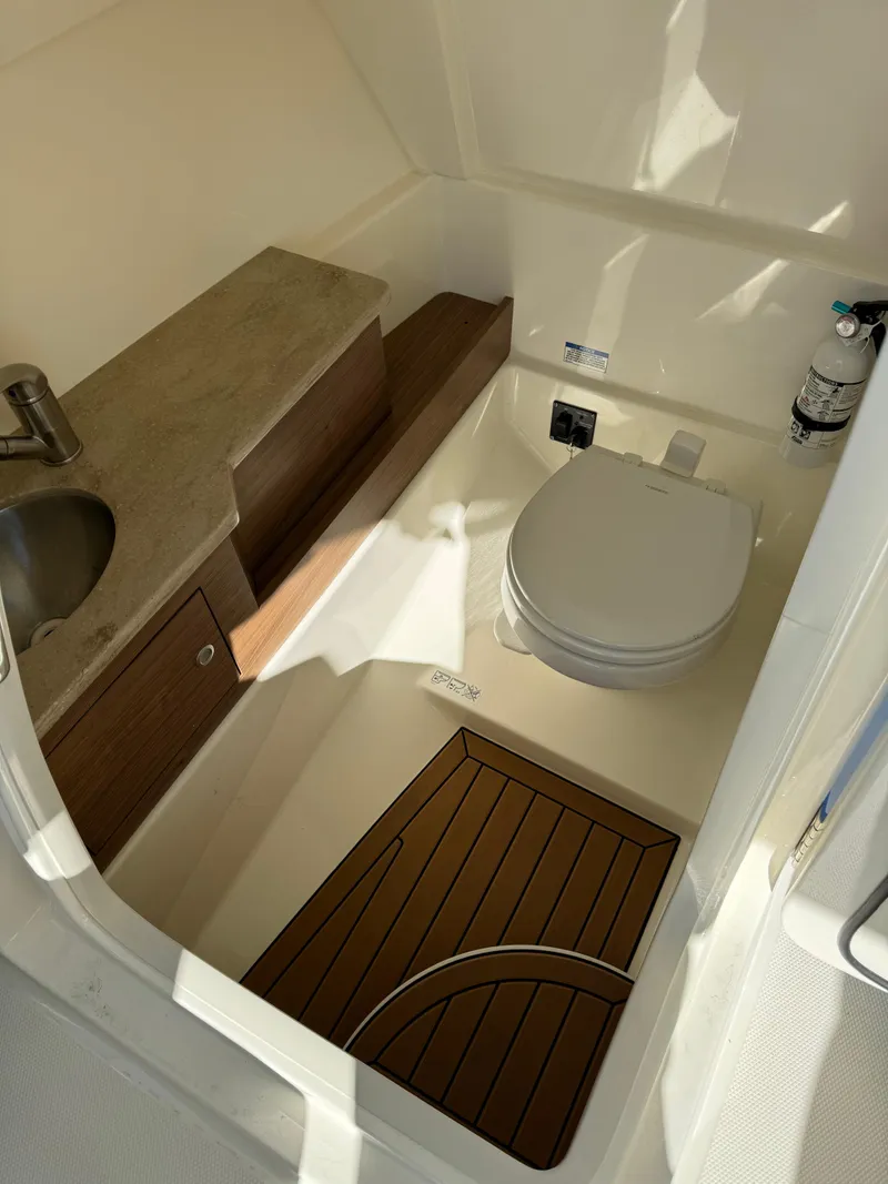 Slide: The Image of 2021 Boston Whaler 280 Vantage boat bathroom with sink and toilet. - 6
