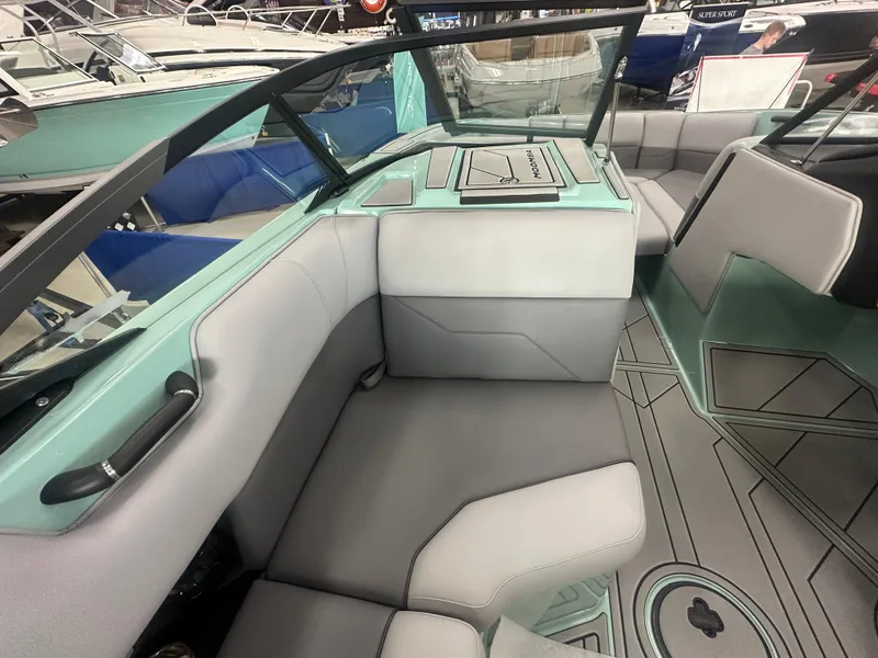 Slide: The Image of 2025 Moomba Max boat interior with gray and teal seating, modern design. - 18