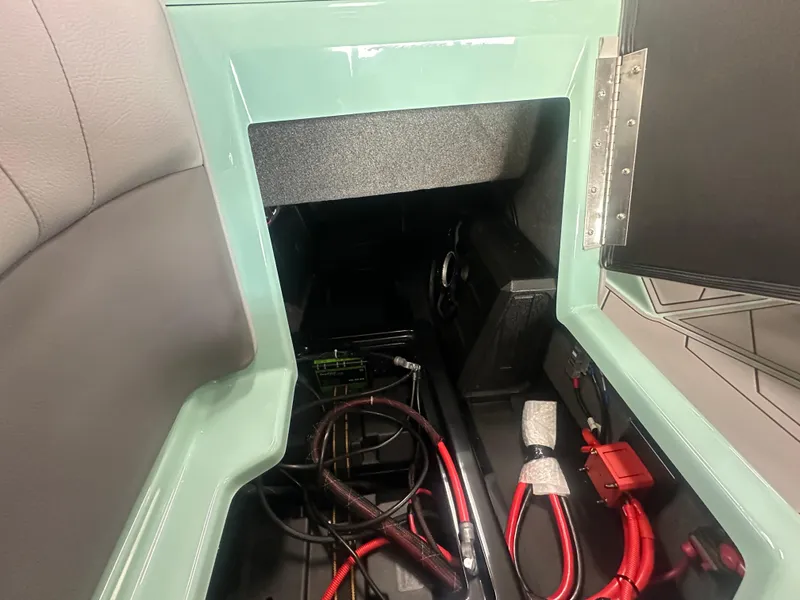 Slide: The Image of 2025 Moomba Max boat storage compartment with cables and equipment. - 19