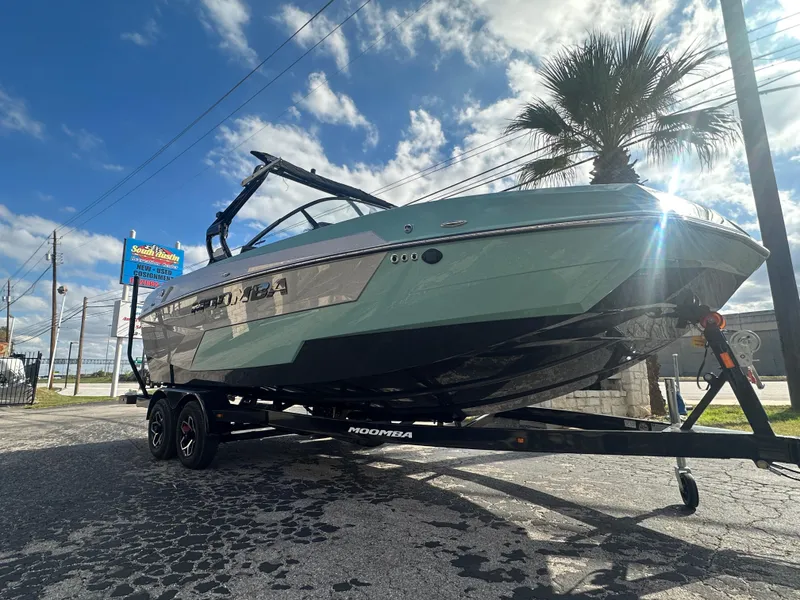 Slide: The Image of 2025 Moomba Max boat on trailer under a sunny sky. - 2